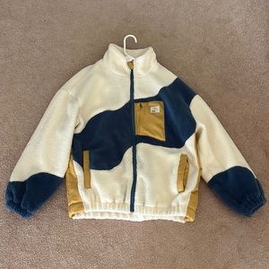 Aelfric Eden Brand. Size L. Colored white, blue, and yellow.